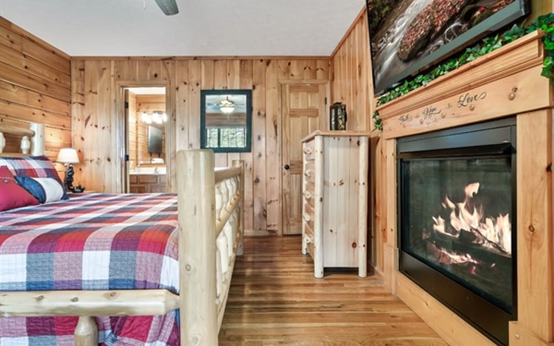 Unwind in a luxurious master suite designed for pure comfort—featuring a plush king-size bed, a cozy fireplace for relaxing evenings, a soothing jacuzzi tub, and a 55" Roku TV for your favorite shows and movies.